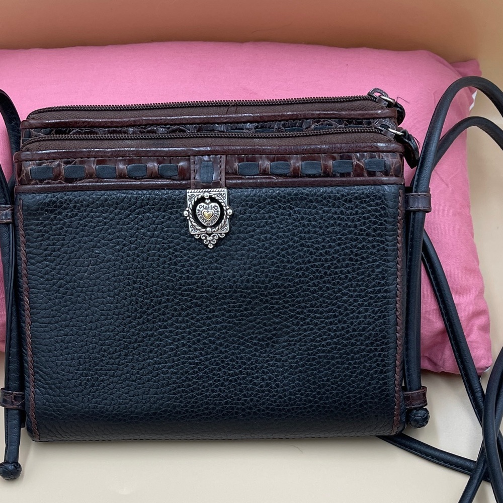 Black and Brown Leather Crossbody Bag with Decorative Silver Emblem